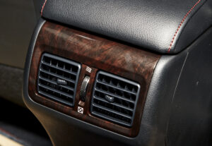 Cropped Image of a passenger air vents wood in a luxury vehicle